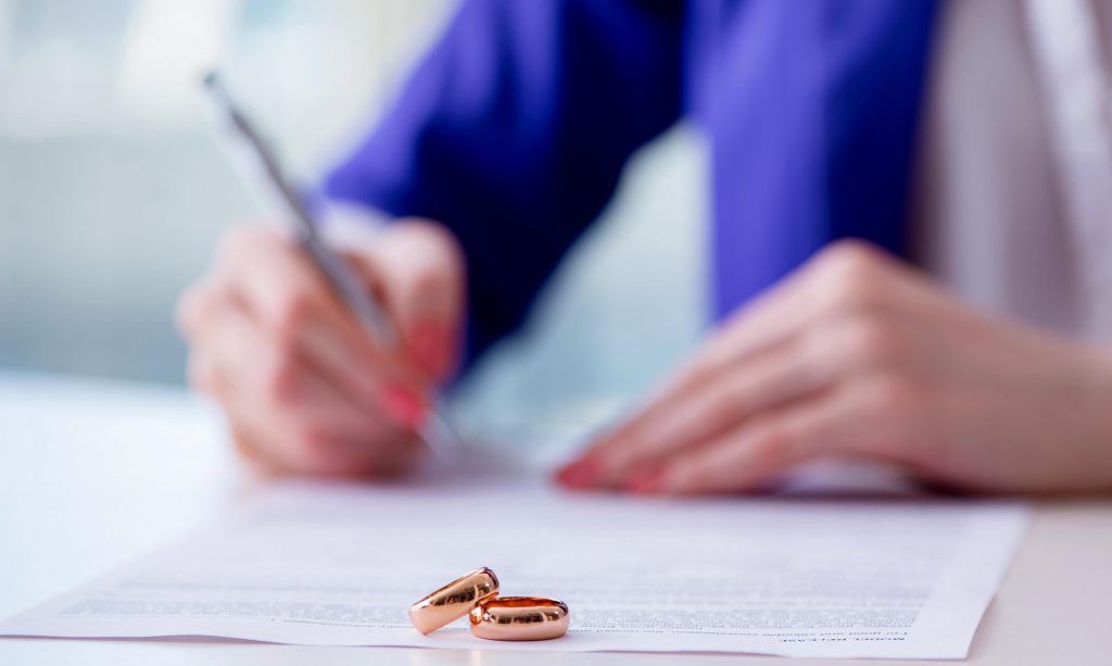 woman preparing divorce forms without a lawyer
